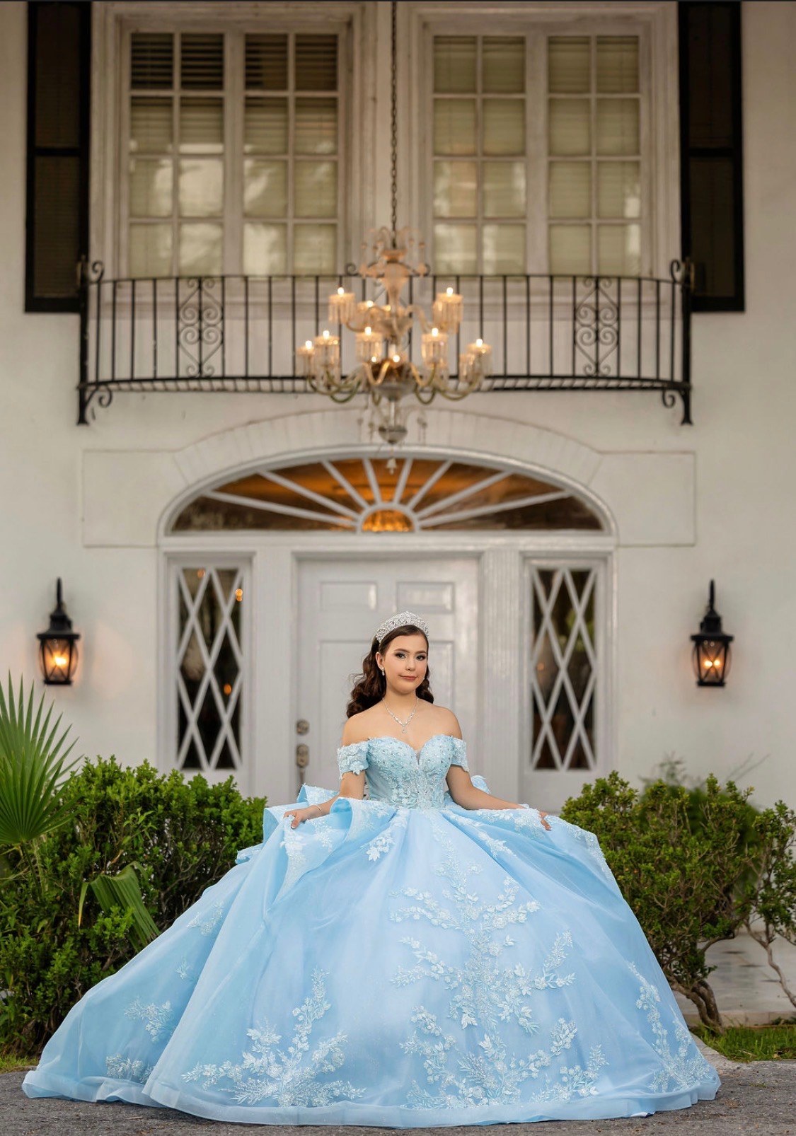 Full length portrait of Carolina beneath the chandelier