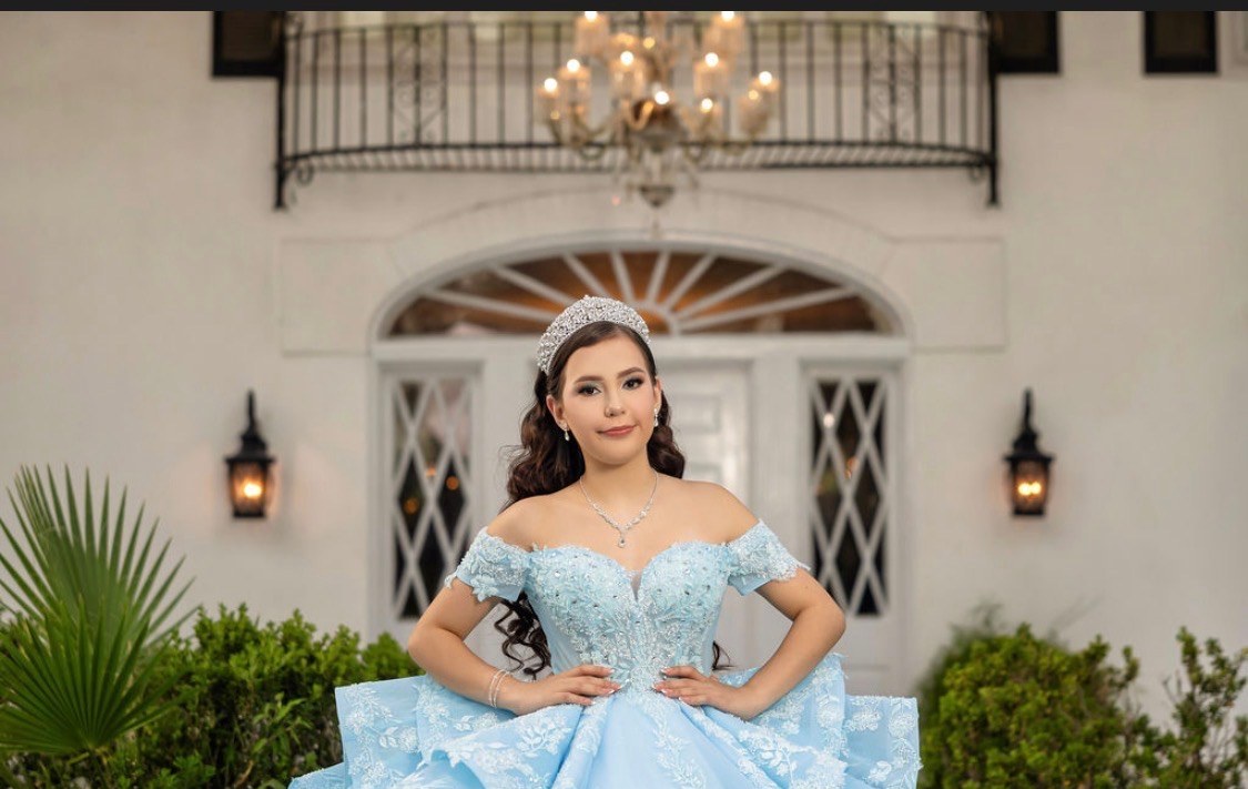 Portrait of Carolina in her crystal tiara on the mansion steps